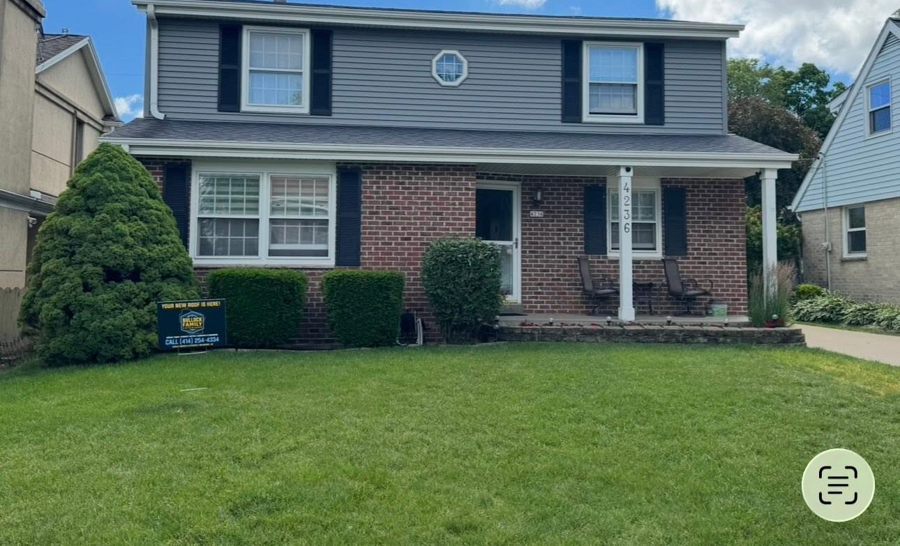 Same home with new gray siding after Ironhorse Exteriors