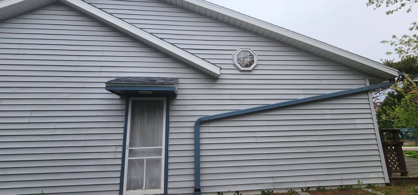 Home with weathered siding before Ironhorse Exteriors